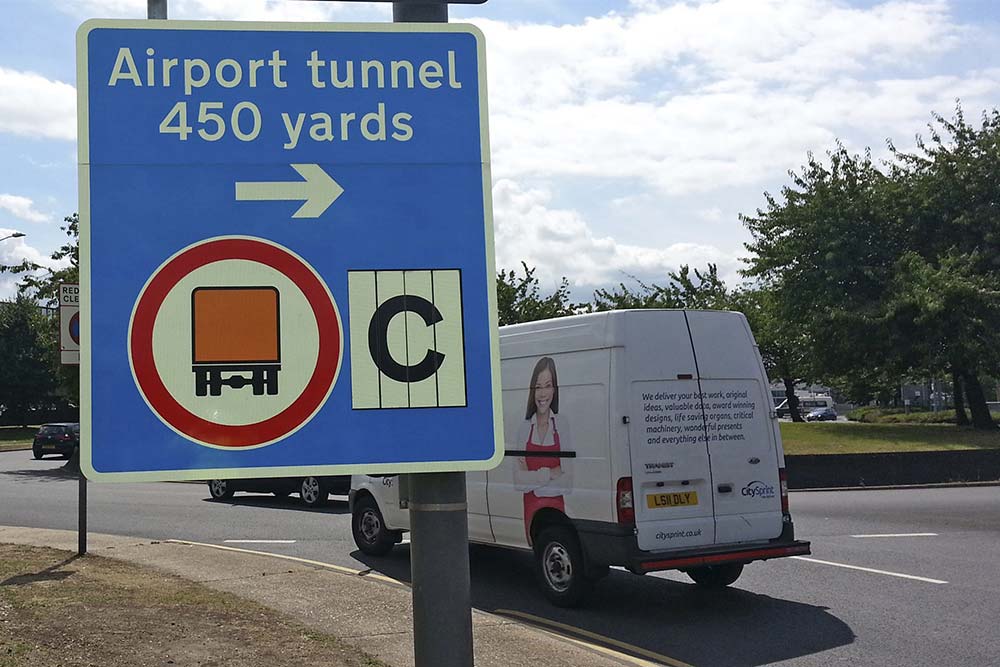 Signage for tunnels above a road